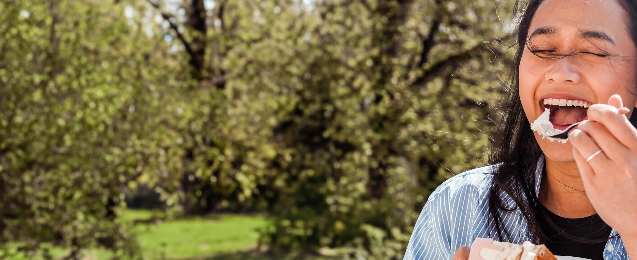 woman enjoying a strawberry layered cake with fruitfilling
